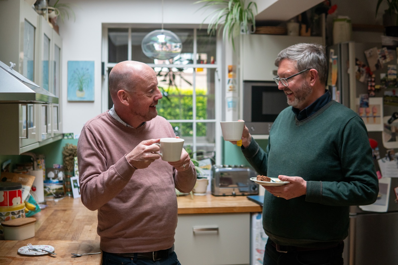 men holding cups of coffee